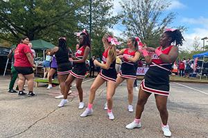 cheerleaders dance at Homecoming tailgate