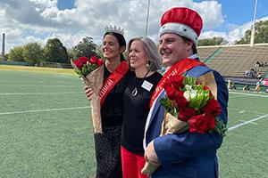 President Baxter celebrates the new Homecoming king and queen